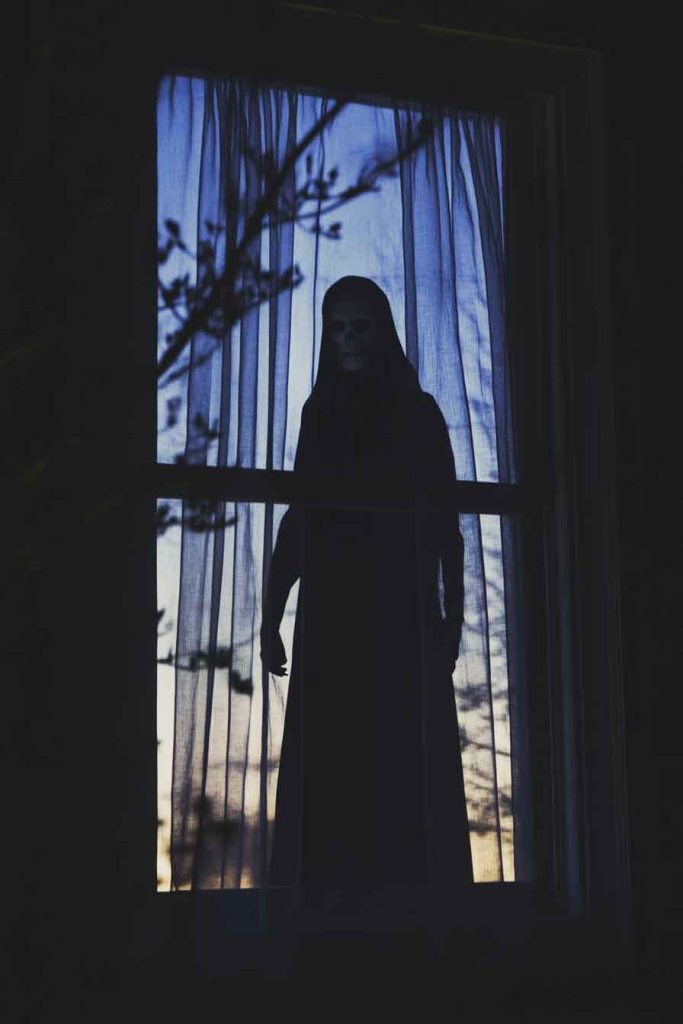 Faceless Figure in the Window