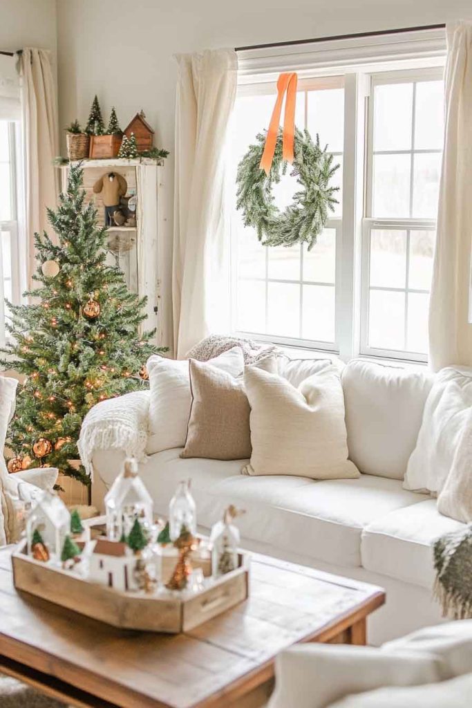 This image shows a bright and cozy cottage living room decorated for Christmas